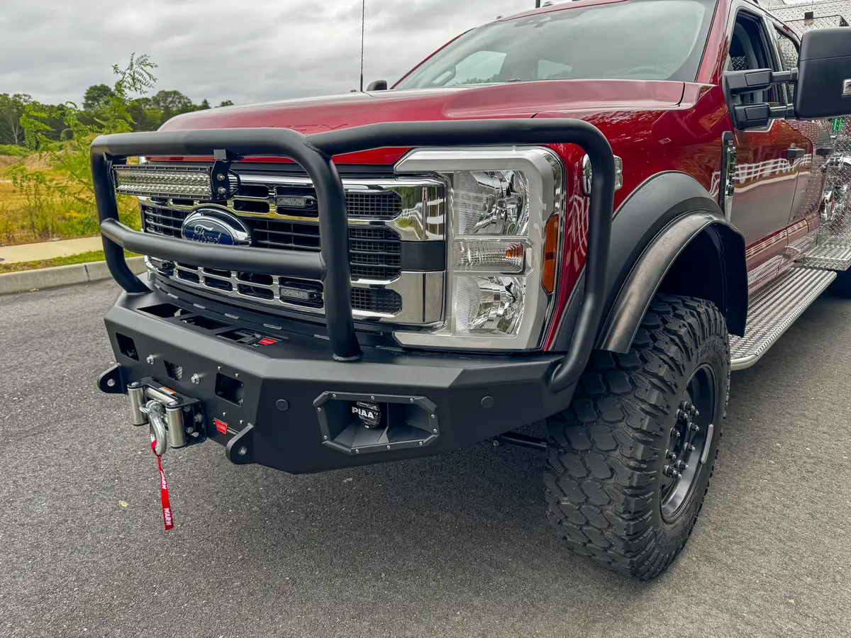 Front bumper close-up showing winch mount, tow point, and control ports.